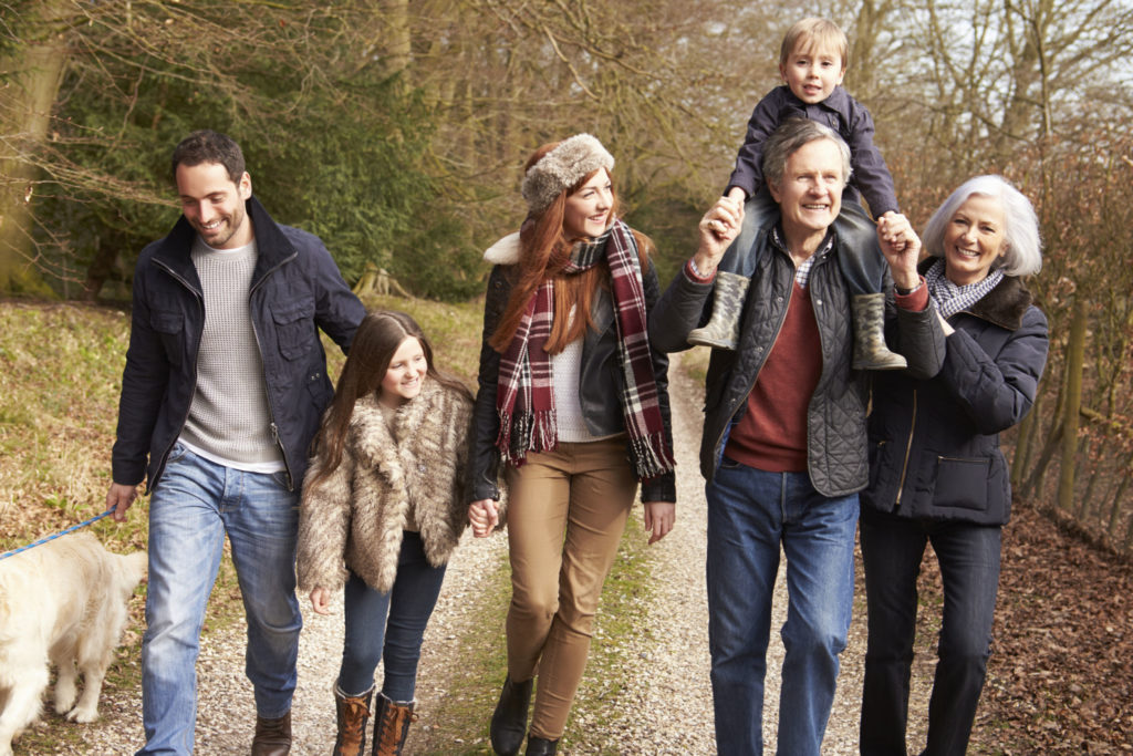 Multi-generation family enjoying an outdoor walk together